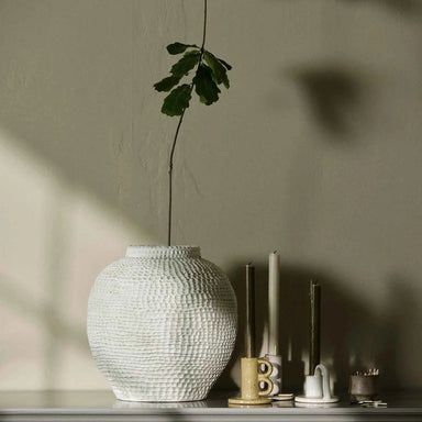 Extra-large ivory textured ceramic stone vase styled in a warm neutral interior.