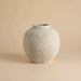 Extra-large ivory ceramic stone vase with a sculptural shape and textured finish.