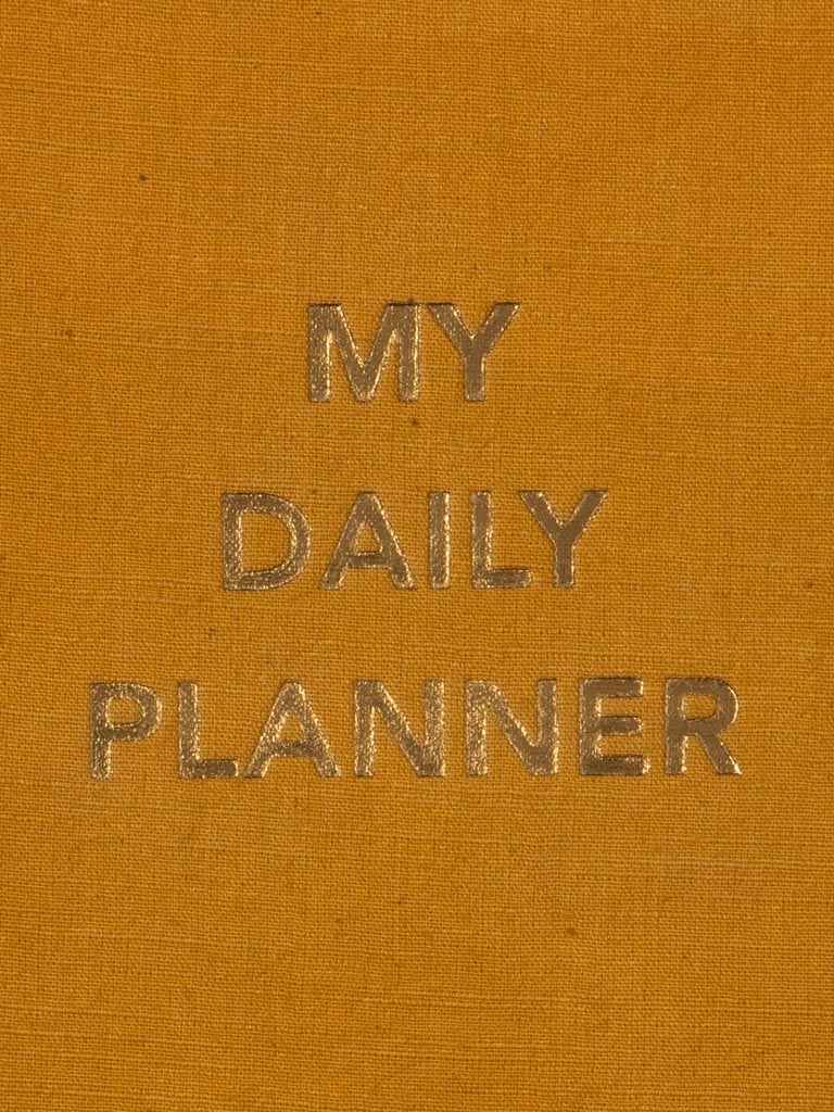 My Daily Planner styled on a desk with stationery in a modern workspace.