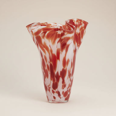 Tall pink and red speckled glass vase with a sculptural wavy rim.