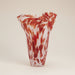 Tall pink and red speckled glass vase with a sculptural wavy rim.