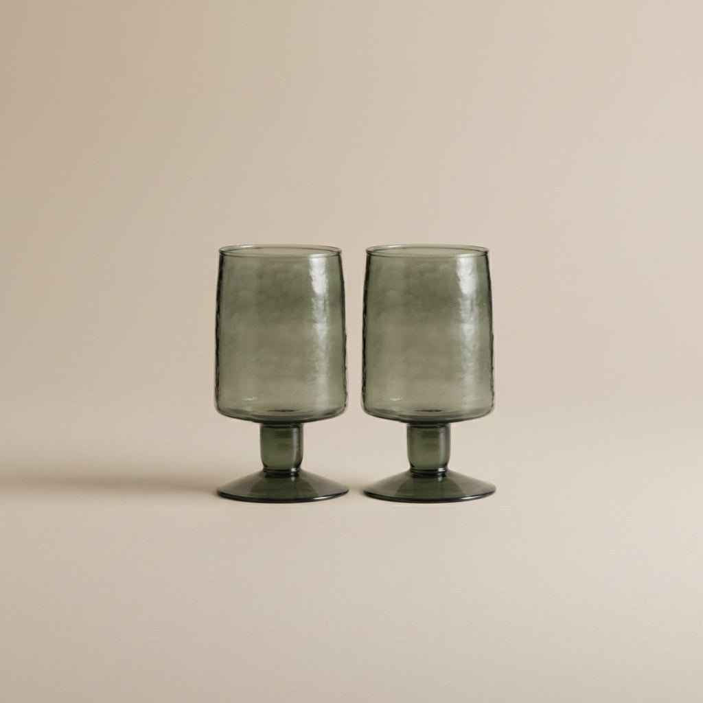Set of two hand-blown dark green drinking glasses with a distinctive artisan finish.
