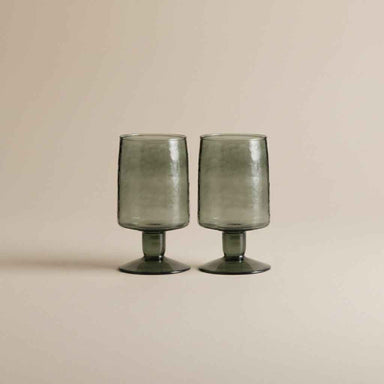 Set of two hand-blown dark green drinking glasses with a distinctive artisan finish.