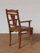 Close-up of the back angle curved wooden frame and craftsmanship of the Art Nouveau inspired accent chair.