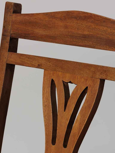 Close-up of the curved wooden frame and craftsmanship of the Art Nouveau inspired accent chair.