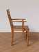 side view  of the curved wooden frame and craftsmanship of the Art Nouveau inspired accent chair.