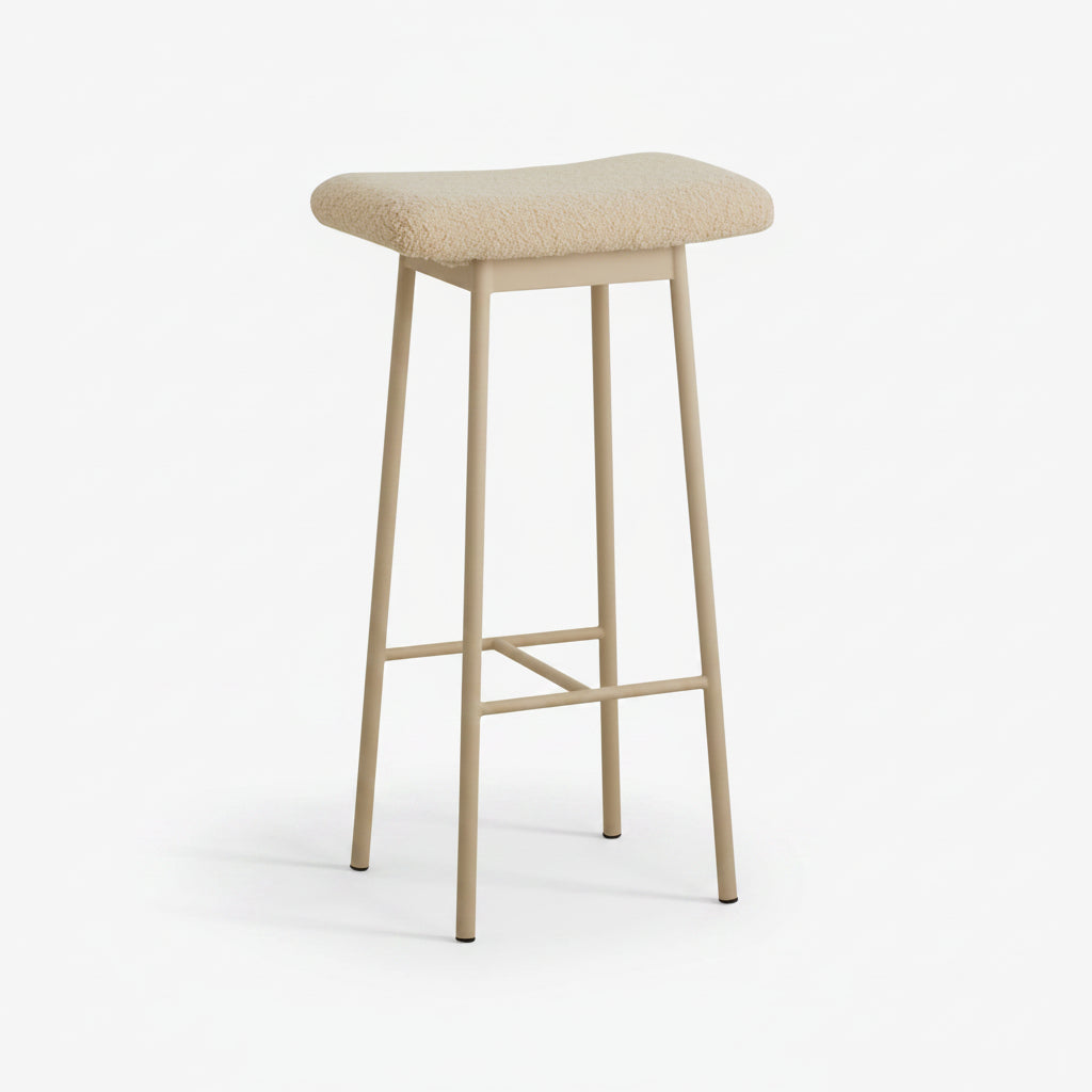 beige metal bar stool with teddy upholstery styled in a modern home interior.