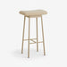 beige metal bar stool with teddy upholstery styled in a modern home interior.