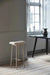 beige metal bar stool with teddy upholstery styled in a scandinavian home interior.