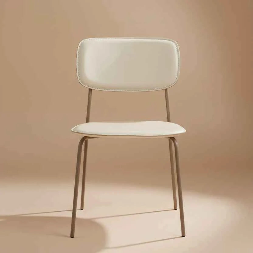 beige modern dining chair with a padded seat, curved backrest and slim metal legs.