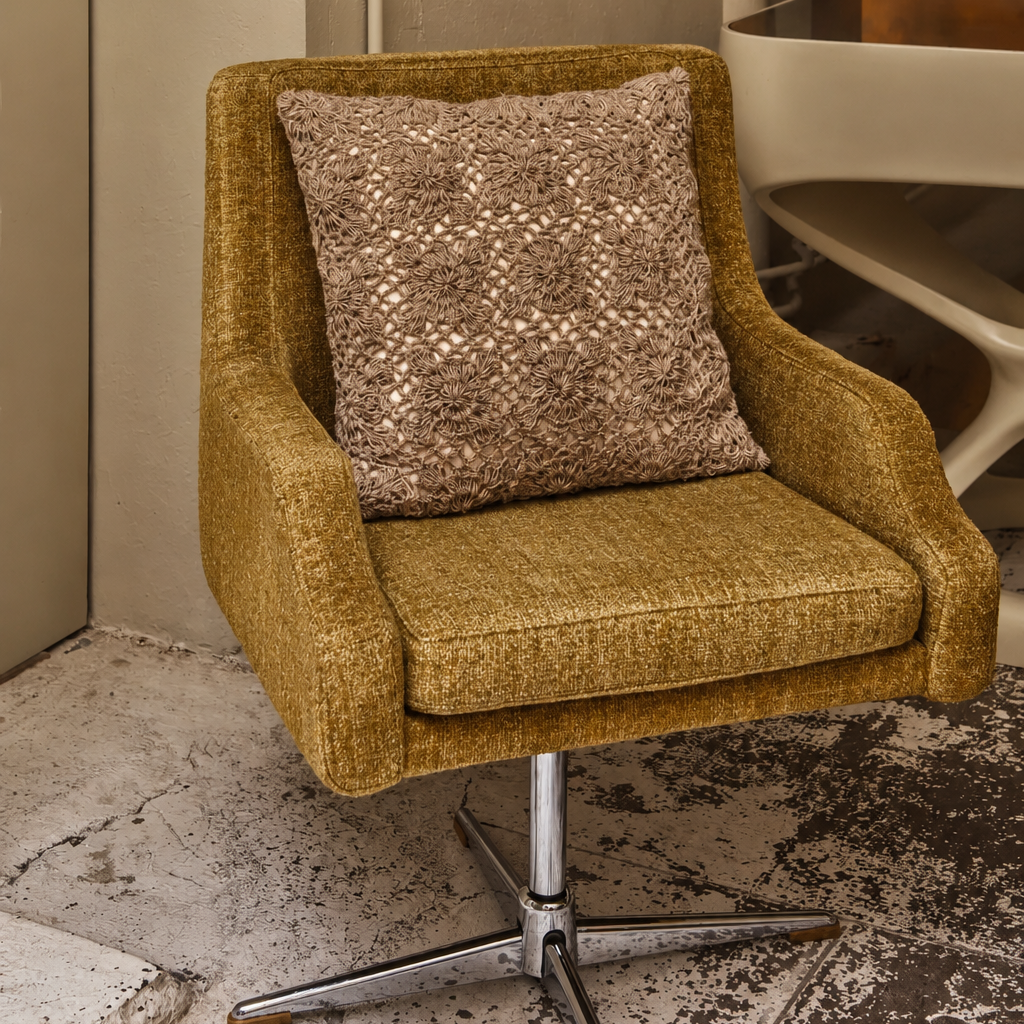 Square beige decorative cushion featuring intricate raised floral embroidery and a richly textured surface, photographed against a soft neutral background.