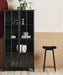 Black metal bar stool with teddy upholstery styled in a modern home interior.