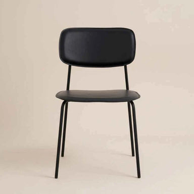Black modern dining chair with a padded seat, curved backrest and slim metal legs.