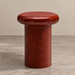 Burgundy sculptural side table with a rounded glossy tabletop and cylindrical pedestal base, inspired by retro 1970s furniture design.