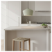 Eco-friendly olive cotton maché lamp shade styled in a contemporary living space with warm ambient lighting.