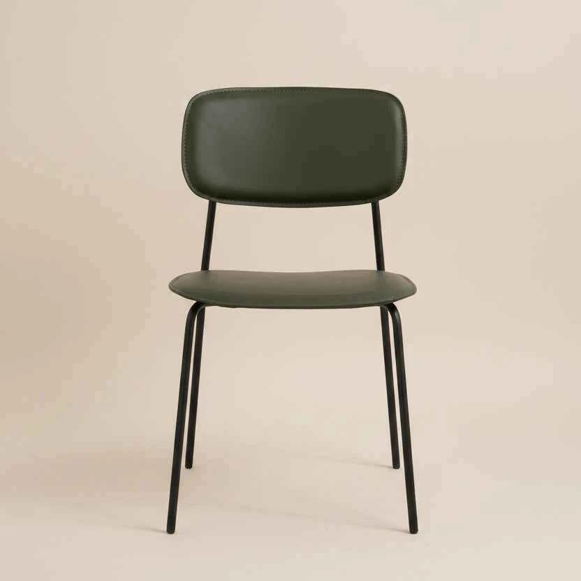 close up of green PU leather dining chair with a cushioned seat, curved backrest and black metal legs.