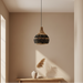 Handcrafted rattan and cotton rope light shade styled in a contemporary dining or living space with warm ambient lighting.