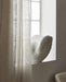 Close-up of the handcrafted sculptural form and textured finish of the shell vase.