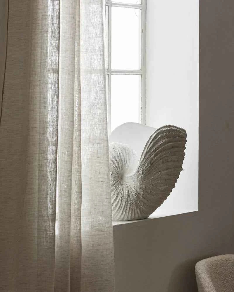 Close-up of the handcrafted sculptural form and textured finish of the shell vase.
