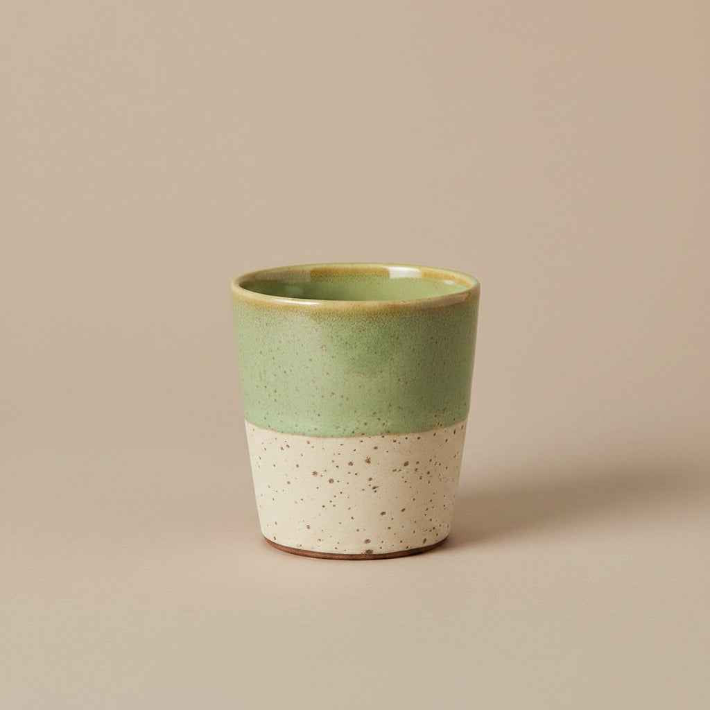Close-up of the reactive glaze and handcrafted finish on the HKLIVING pale green and beige ceramic mug.