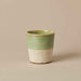 Close-up of the reactive glaze and handcrafted finish on the HKLIVING pale green and beige ceramic mug.