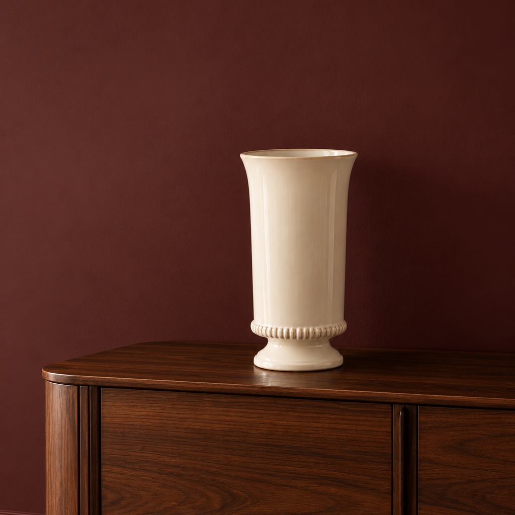 Discover our elegant ivory ceramic vase with a sculptural silhouette and vintage-inspired detailing. A timeless statement piece for beautifully curated interiors.