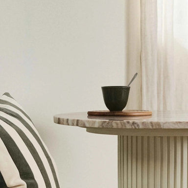 Large acacia wood coaster styled on a contemporary coffee table with a mug and modern home décor.