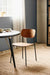 Mid-century walnut dining chair with black metal legs styled in a contemporary dining room.