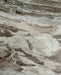 Close-up of the natural beige marble grain highlighting the unique character and finish of the dining table.