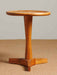 Round mid-century side table with a timeless design, clean lines and a natural wood finish.