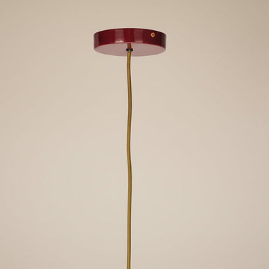 Close-up of the sculptural form and raspberry finish of the contemporary ceiling light.