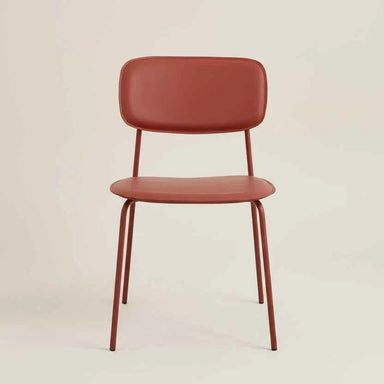 Red modern dining chair with a padded seat, curved backrest and slim metal legs.