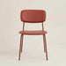 Red modern dining chair with a padded seat, curved backrest and slim metal legs.