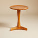 Round mid-century side table with a timeless design, clean lines and a natural wood finish.