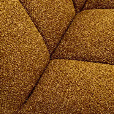 Close-up of the soft mustard boucle fabric highlighting the texture and craftsmanship of the sofa chair.