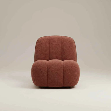 front on Sculptural red boucle sofa chair with soft textured upholstery, curved lines and a contemporary design.