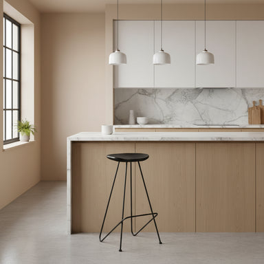 Set of 2 minimalist black iron bar stools styled at a contemporary kitchen island.