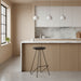 Set of 2 minimalist black iron bar stools styled at a contemporary kitchen island.