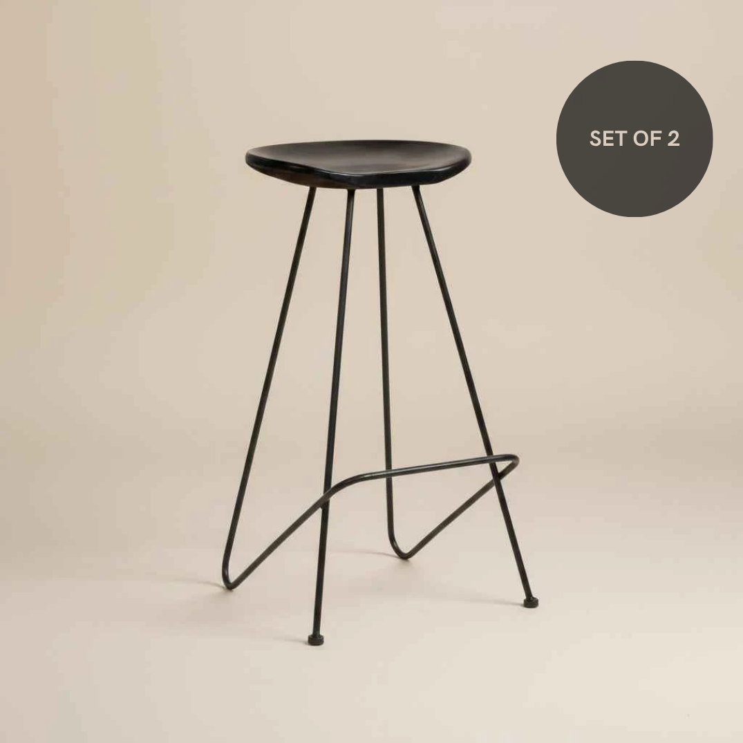 Set of 2 minimalist black iron bar stools with a contemporary design and clean, modern lines.