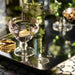 Set of 2 pink Art Deco glasses styled on a contemporary dining table.