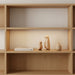 Set of 2 plywood penguin ornaments styled on a shelf in a contemporary home.