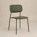 rside profile of a green PU leather dining chair with a cushioned seat, curved backrest and black metal legs.