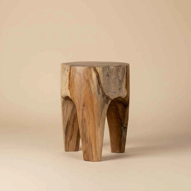 Solid teak wood three-leg stool handcrafted from natural timber with an organic sculptural design.